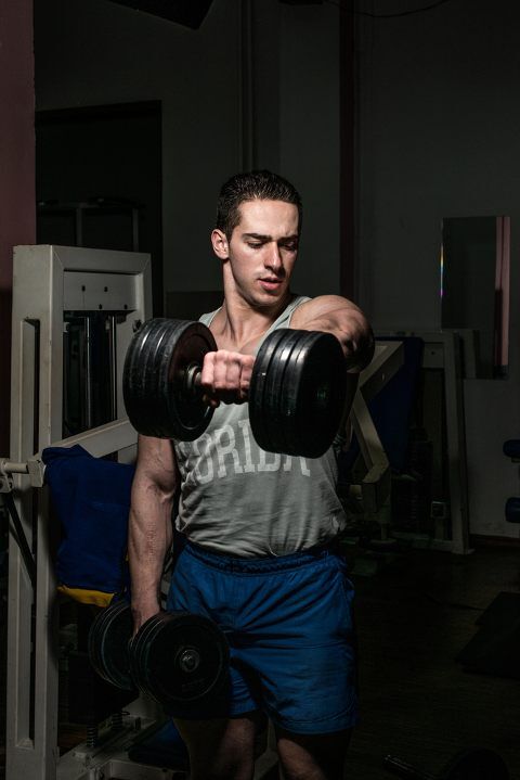 Man doing dumbbell shoulder front raise