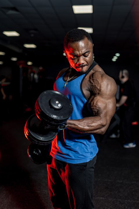 Man exercising with dumbbells at the gym