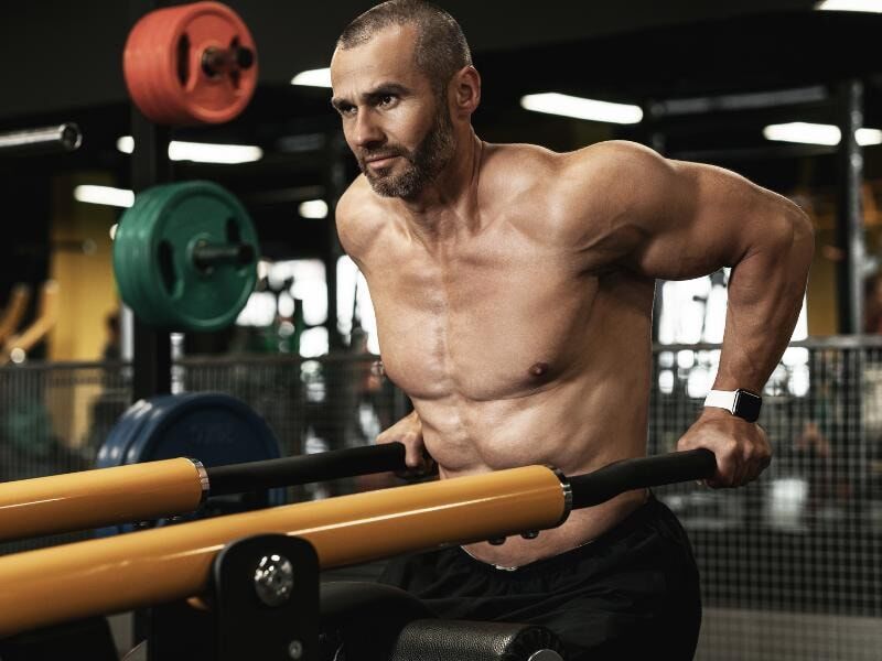 man doing v bar dips