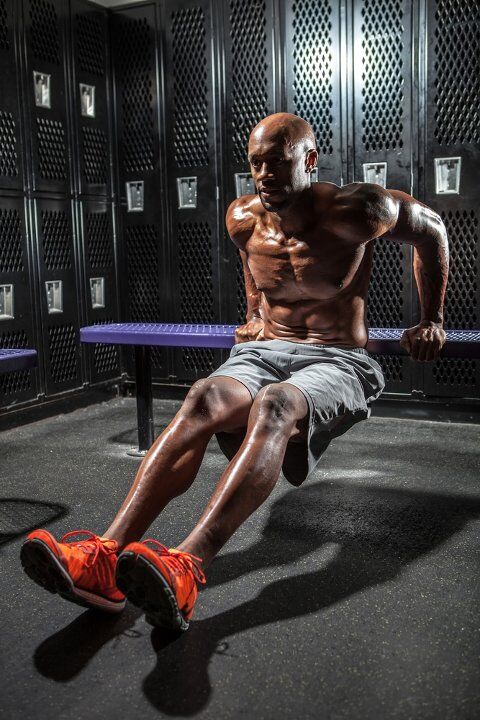 Man doing reverse push ups with bench