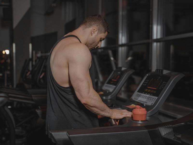 man preparing to run on treadmill